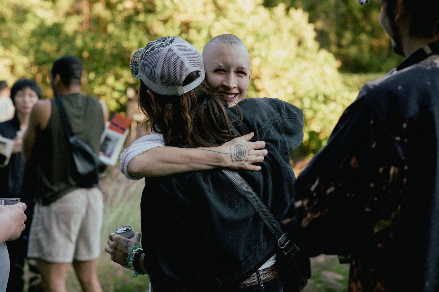 Two friends embracing at a HIT show